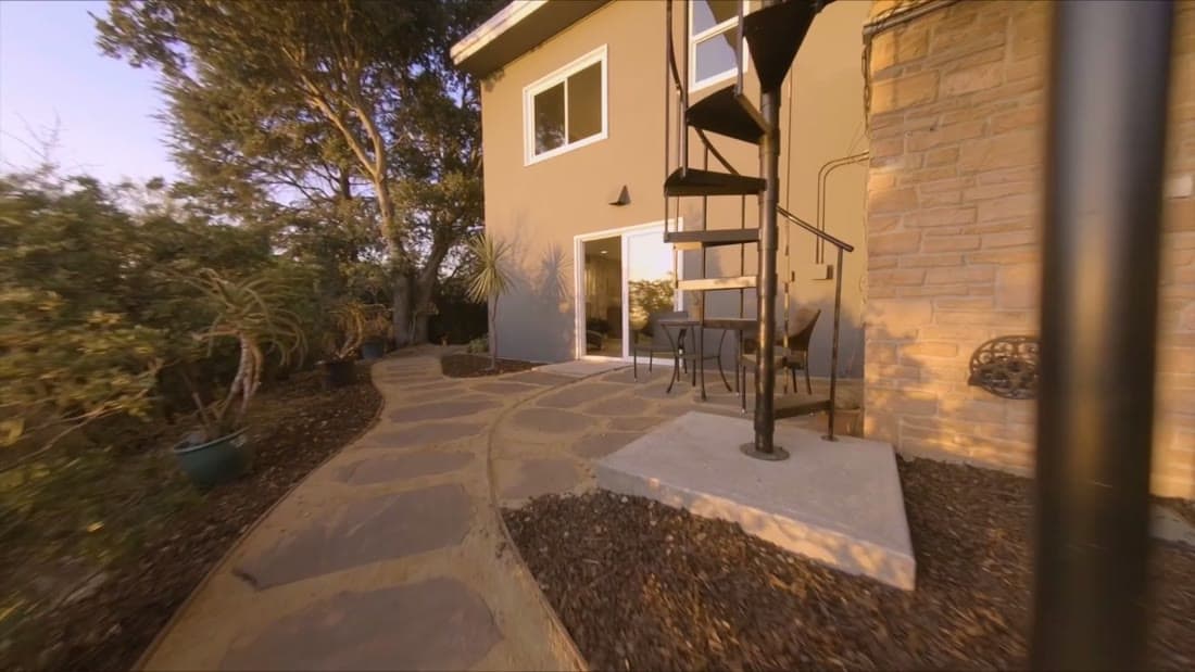 Stone patio with spiral staircase at golden hour